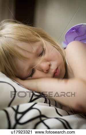Stock Image - Young girl having a nap, Regina, Saskatchewan, Canada. Fotosearch