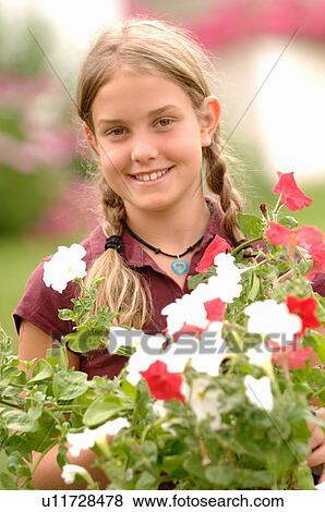 Young girl holding flowers, Regina, Saskatchewan View Large Photo Image Stock Photo - Young girl holding flowers, Regina, Saskatchewan. Fotosearch