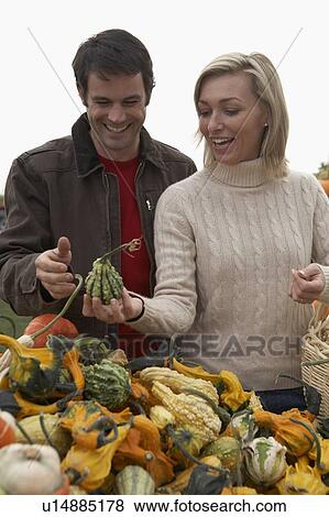Couple looking at organic squash, Ladner, British Columbia, Canada View Large Photo Image Stock Photo - Couple looking at organic squash, Ladner, British Columbia, Canada. Fotosearch