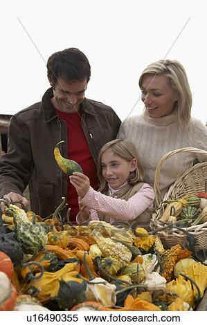 Stock Photography - Family looking at organic squash, Ladner, British Columbia, Canada. Fotosearch