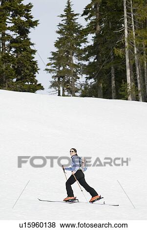 Stock Photo - A woman backcountry skiing, Strathcona Provincial Park near Courtenay, BC, Canada. Fotosearch