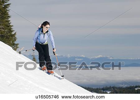 Stock Photograph - A woman backcountry skiing, Strathcona Provincial Park near Courtenay, BC, Canada. Fotosearch