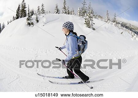 Stock Photo - A woman cross-country skiing, Strathcona Provincial Park near Courtenay, BC, Canada. Fotosearch