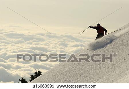 Silhouette of a skier above the clouds, Port Alberini, Vancouver Island, B. C. View Large Photo Image Stock Photography - Silhouette of a skier above the clouds, Port Alberini, Vancouver Island, B. C.. Fotosearch