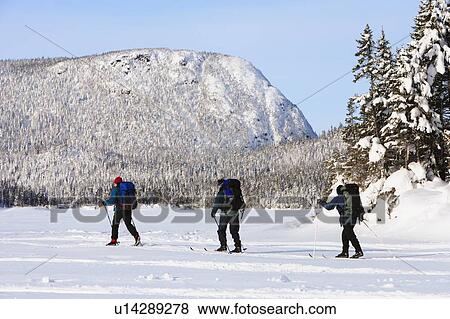 Stock Photo - View of skiers on Thibault lake, Quebec, Canada. Fotosearch
