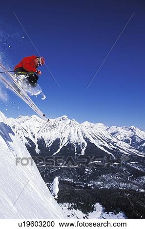 Young man catches air while skiing at Fernie Alpine Resort, Fernie, British Columbia, Canada. View Large Photo Image Stock Image - Young man catches air while skiing at Fernie Alpine Resort, Fernie, British Columbia, Canada.. Fotosearch