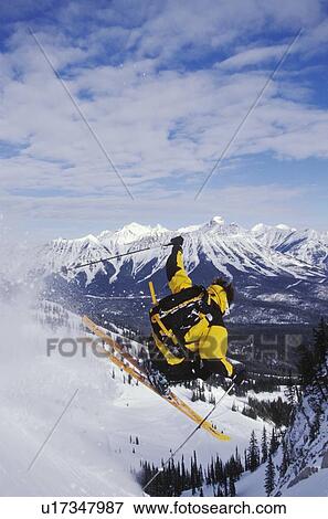 Stock Photo - Young man catches air while telemarking at Fernie Alpine Resort, Fernie, British Columbia, Canada. Fotosearch