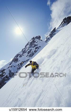 Young man skiing fresh powder on steep slope at Blackcomb Mountain, Whistler, British Columbia, Canada. View Large Photo Image Picture - Young man skiing fresh powder on steep slope at Blackcomb Mountain, Whistler, British Columbia, Canada.. Fotosearch