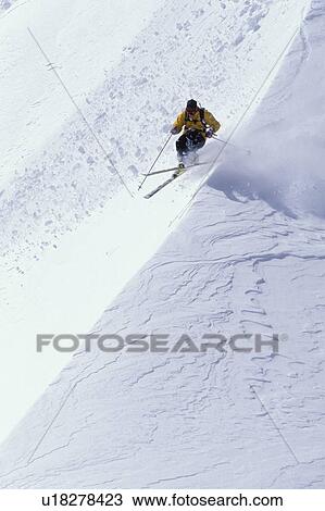 Young man skiing fresh powder on steep slope at Island Lake Resort, Fernie, British Columbia, Canada. View Large Photo Image Stock Image - Young man skiing fresh powder on steep slope at Island Lake Resort, Fernie, British Columbia, Canada.. Fotosearch