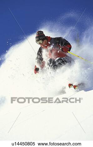 Young man skiing fresh powder on steep slope at Island Lake Resort, Fernie, British Columbia, Canada. View Large Photo Image Stock Photography - Young man skiing fresh powder on steep slope at Island Lake Resort, Fernie, British Columbia, Canada.. Fotosearch