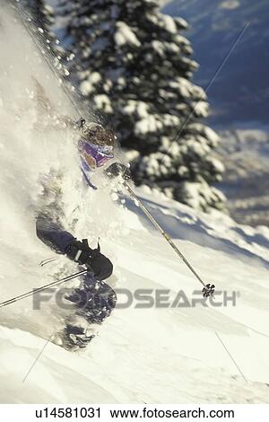 Young woman skiing deep powder at Fernie Alpine Resort, Fernie, British Columbia, Canada. View Large Photo Image Stock Image - Young woman skiing deep powder at Fernie Alpine Resort, Fernie, British Columbia, Canada.. Fotosearch