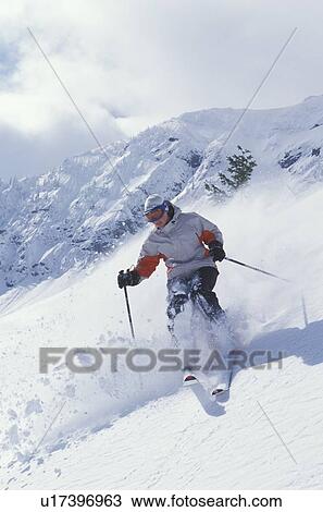 Young woman skiing fresh powder at Fernie Alpine Resort, Fernie, British Columbia, Canada. View Large Photo Image Stock Image - Young woman skiing fresh powder at Fernie Alpine Resort, Fernie, British Columbia, Canada.. Fotosearch