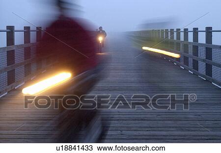 Blurred Cyclists on a path at night with lights, Victoria, Vancouver Island, B. C. View Large Photo Image Stock Image - Blurred Cyclists on a path at night with lights, Victoria, Vancouver Island, B. C.. Fotosearch