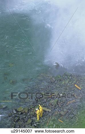 Stock Photo - Brandywine Falls, near Whistler, with fisherman at base of fall. Fotosearch