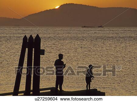 Father and son fishing off dock, sunset, San Juan Islands, Washington View Large Photo Image Picture - Father and son fishing off dock, sunset, San Juan Islands, Washington. Fotosearch
