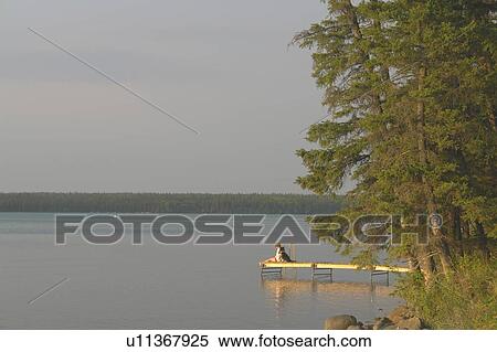 Woman on dock Clear Lake; Canada, Manitoba, Riding Mountain National Park View Large Photo Image Stock Photography - Woman on dock Clear Lake; Canada, Manitoba, Riding Mountain National Park. Fotosearch