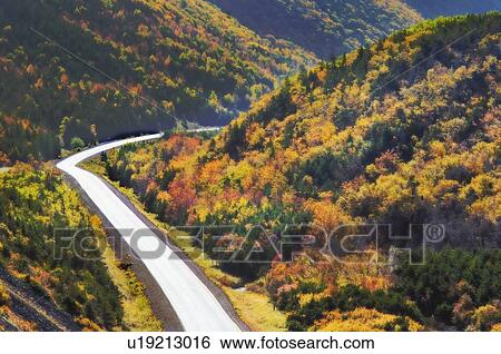 Stock Photograph - Cabot Trail winds through autumn colors in Cape Breton Highlands National Park.. Fotosearch