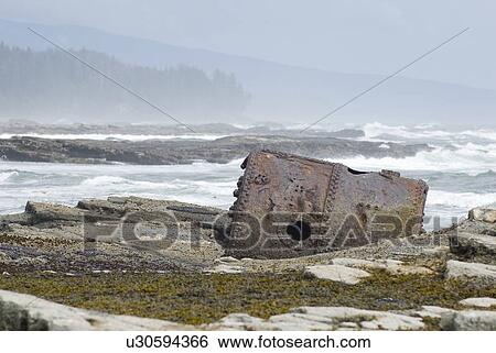 Stock Photograph - Rusty Steamship Boiler that has been in this place since the ship wrecked in 1898, Pacific Rim National Park, B. C.. Fotosearch
