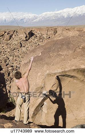 A man preparing to climb a boulder near Bishop, California View Large Photo Image Stock Photo - A man preparing to climb a boulder near Bishop, California. Fotosearch