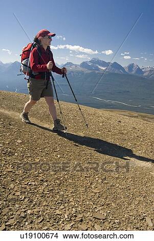Picture - A woman (20-25) smiles while hiking in the alpine; Canada, Alberta, Jasper National Park, Skyline Trail. Fotosearch