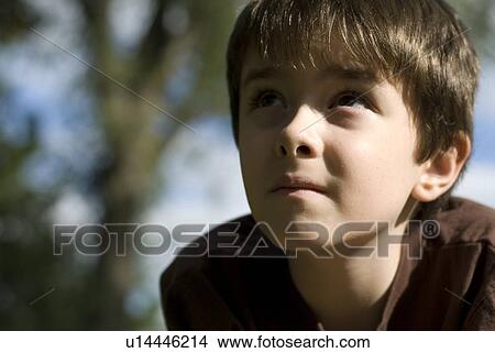 Picture - Six year old boy looking upward, Winnipeg, Canada. Fotosearch