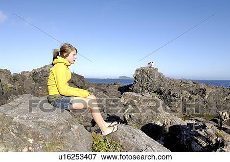 Teen girl sitting on rocks overlooking Pacific Ocean, Vancouver Island, Canada View Large Photo Image Stock Photo - Teen girl sitting on rocks overlooking Pacific Ocean, Vancouver Island, Canada. Fotosearch