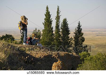 Teen sister with camera, younger sister seated outdoors, Saskatchewan View Large Photo Image Stock Image - Teen sister with camera, younger sister seated outdoors, Saskatchewan. Fotosearch