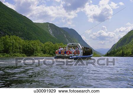 Stock Photo - View of Le Menaud riverboat on Malbaie river. Fotosearch