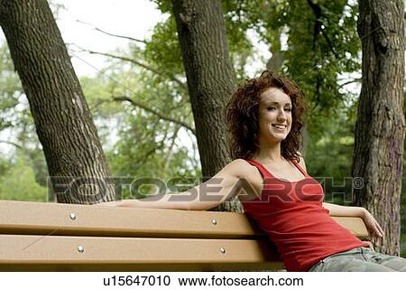 Woman relaxing on park bench, Winnipeg, Manitoba, Canada View Large Photo Image Stock Image - Woman relaxing on park bench, Winnipeg, Manitoba, Canada . Fotosearch