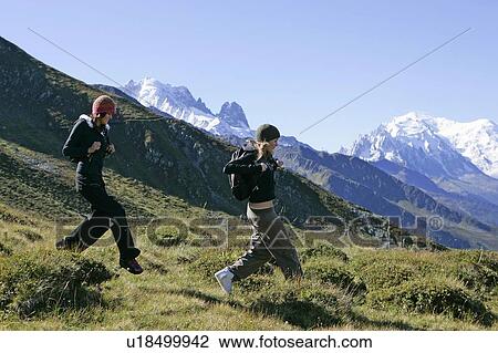 Stock Image - Young girls (19) hiking in front of Mont Blanc, Col de Balme Chamonix, France. Fotosearch