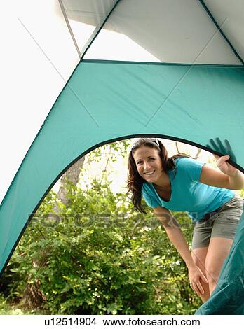 Young woman looking into opening of tent, Regina, Saskatchewan View Large Photo Image Picture - Young woman looking into opening of tent, Regina, Saskatchewan. Fotosearch