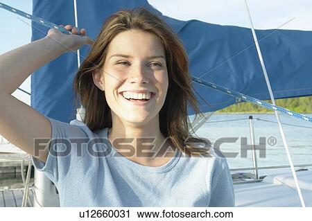 Young woman wearing hemp shirt on sail boat, Clear Lake, Riding Mountain National Park, Manitoba, Canada View Large Photo Image Stock Image - Young woman wearing hemp shirt on sail boat, Clear Lake, Riding Mountain National Park, Manitoba, Canada. Fotosearch