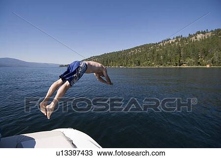 Youth diving off back of four-stroke engine boat, Okanagan Centre, BC Canada. View Large Photo Image Stock Image - Youth diving off back of four-stroke engine boat, Okanagan Centre, BC Canada.. Fotosearch