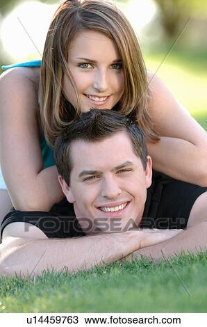Boy and girl teenagers in grass at park, Regina, Saskatchewan View Large Photo Image Stock Image - Boy and girl teenagers in grass at park, Regina, Saskatchewan. Fotosearch