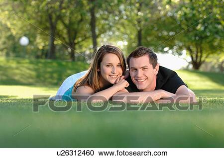 Boy and girl teenagers in grass at park, Regina, Saskatchewan View Large Photo Image Stock Image - Boy and girl teenagers in grass at park, Regina, Saskatchewan. Fotosearch