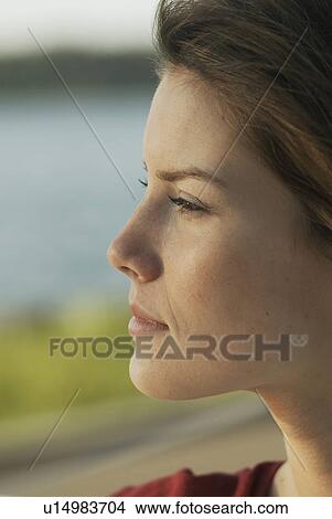 Picture - Profile of young woman outdoors, Clear Lake, Riding Mountain National Park, Manitoba, Canada. Fotosearch
