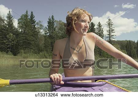 Picture - Smiling woman in kayak, Lake Katherine, Riding Mountain National Park, Manitoba, Canada. Fotosearch
