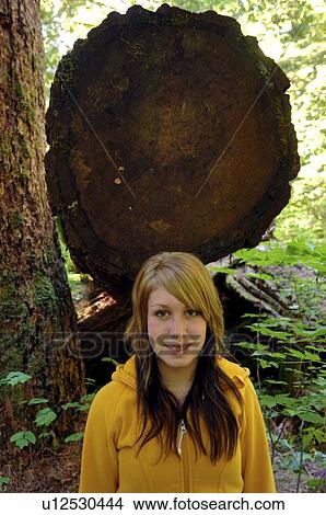 Picture - Teen girl portrait in front of Douglas Fir, Vancouver Island, Canada. Fotosearch
