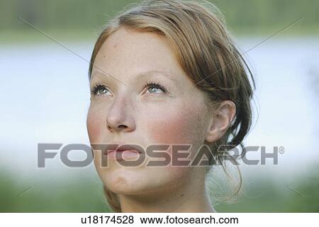Stock Photo - Woman with eyes upward, Grayling Lake, Riding Mountain National Park, Manitoba, Canada. Fotosearch