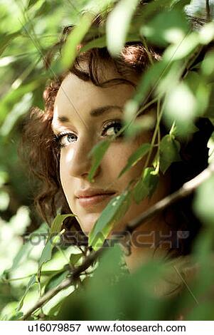 Woman's face behind green leaves, Winnipeg, Manitoba, Canada View Large Photo Image Stock Photo - Woman's face behind green leaves, Winnipeg, Manitoba, Canada. Fotosearch