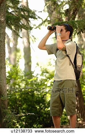 Young man in woods w/binoculars, Regina, Saskatchewan View Large Photo Image Stock Image - Young man in woods w/binoculars, Regina, Saskatchewan. Fotosearch