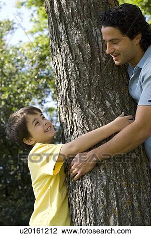 Six year old boy and father hugging tree, Assiniboine Park, Winnipeg, Canada View Large Photo Image Stock Image - Six year old boy and father hugging tree, Assiniboine Park, Winnipeg, Canada. Fotosearch