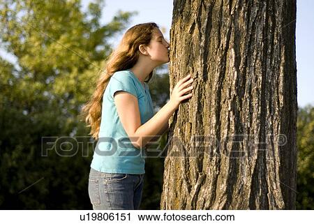 Twelve year old gives a kiss to large tree in Assiniboine Park, Winnipeg, Canada View Large Photo Image Stock Image - Twelve year old gives a kiss to large tree in Assiniboine Park, Winnipeg, Canada. Fotosearch