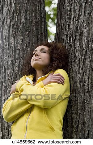 Woman stands between two trees, Winnipeg, Manitoba, Canada View Large Photo Image Stock Image - Woman stands between two trees, Winnipeg, Manitoba, Canada. Fotosearch