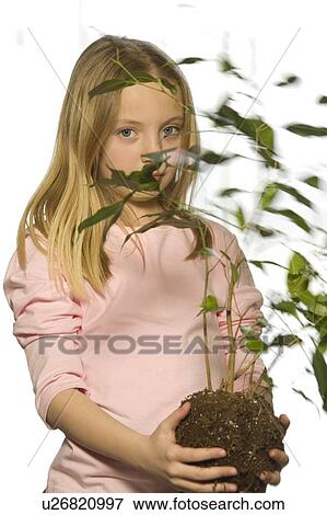 Young girl with tree sapling View Large Photo Image Stock Photo - Young girl with tree sapling. Fotosearch