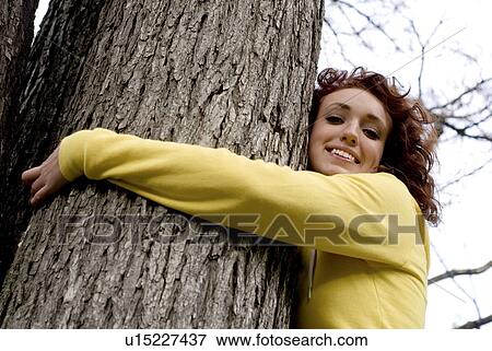Young woman hugs a tree, Winnipeg, Manitoba, Canada View Large Photo Image Stock Photo - Young woman hugs a tree, Winnipeg, Manitoba, Canada. Fotosearch