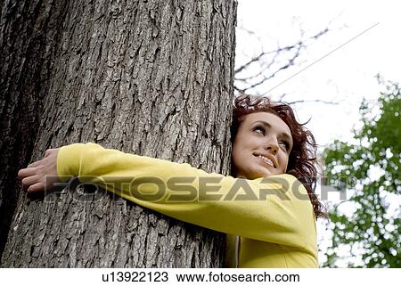 Young woman with arms around tree, Munson Park, Winnipeg, Canada View Large Photo Image Stock Image - Young woman with arms around tree, Munson Park, Winnipeg, Canada. Fotosearch