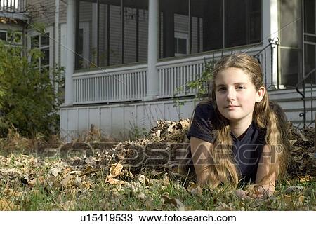 Girl lying in the leaves, Winnipeg, Canada View Large Photo Image Stock Image - Girl lying in the leaves, Winnipeg, Canada. Fotosearch