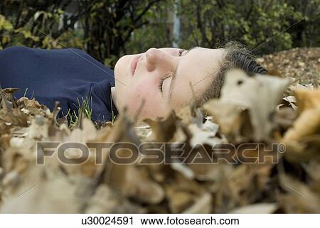 Girl lying in the leaves, Winnipeg, Canada View Large Photo Image Stock Image - Girl lying in the leaves, Winnipeg, Canada. Fotosearch