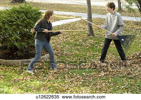 Teen brother and sister fighting with rakes, Winnipeg, Canada View Large Photo Image Stock Photography - Teen brother and sister fighting with rakes, Winnipeg, Canada. Fotosearch